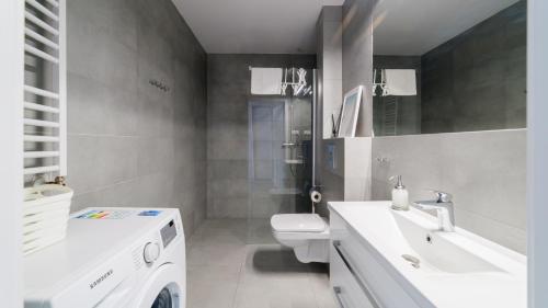 a white bathroom with a sink and a toilet at Triventi Mountain Residence, Sun & Snow in Karpacz