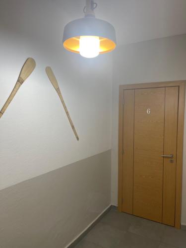 a room with two wooden bats hanging on the wall at LA VILLA M in Conakry