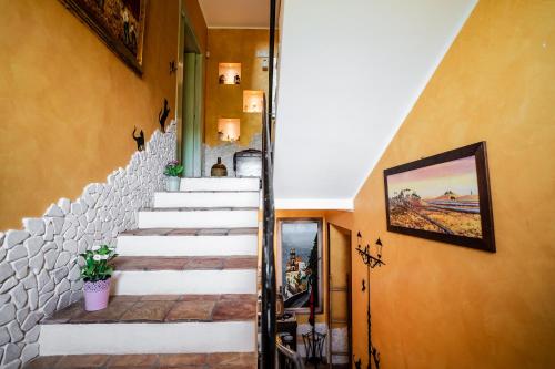 a staircase in a house with a painting on the wall at Villa D'Anzi B&B in Ginosa