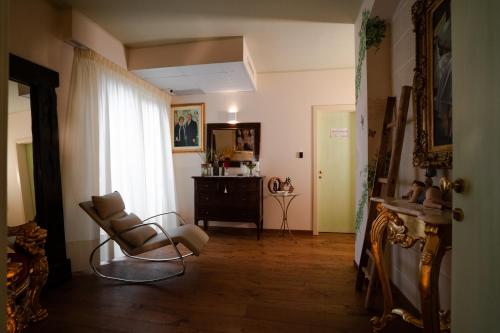 a living room with a chair and a dresser at Villa D'Anzi B&B in Ginosa
