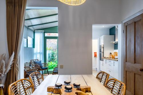 a kitchen and dining room with a table and chairs at Farndale Den in York