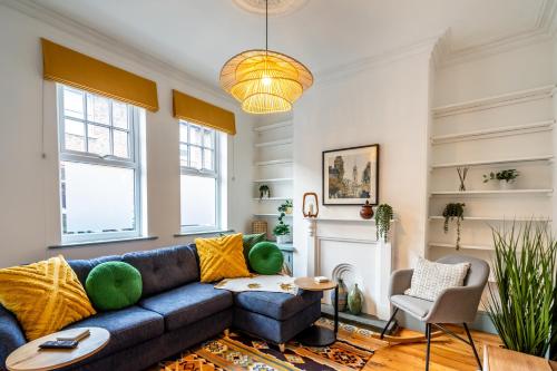 a living room with a blue couch and a fireplace at Farndale Den in York