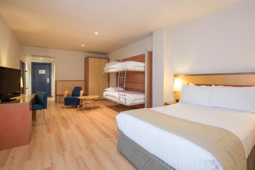 a hotel room with a bed and a television at Hotel Castellon Center Affiliated by Meliá in Castellón de la Plana
