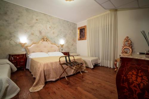 a bedroom with a bed and a chair in it at Villa D'Anzi B&B in Ginosa
