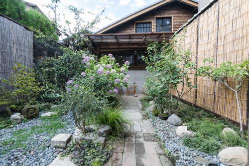 a garden in front of a wooden house at お宿梅夜Guesthouse Umeya in Kyoto