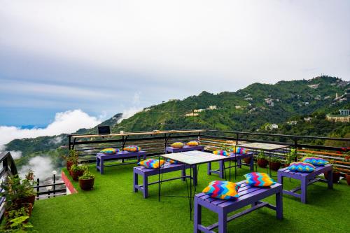 a group of tables with colorful balls on top of a hill at goSTOPS Mussoorie, Library Road in Mussoorie