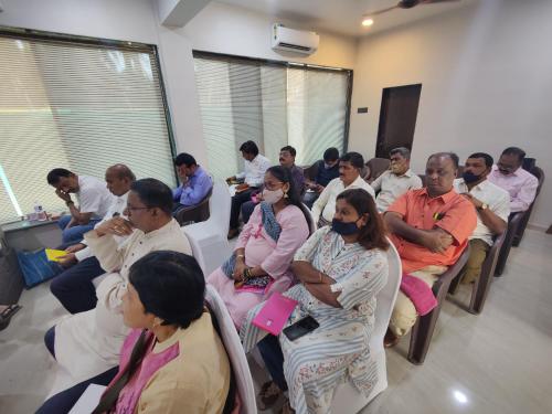 a group of people sitting in a room at Coastal Bay Inn by Green Apple Stays in Alibaug