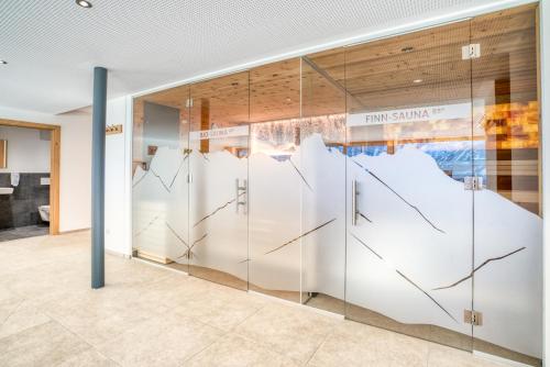 a glass wall in a building with a map on it at HUS23 with Wellness in Schröcken