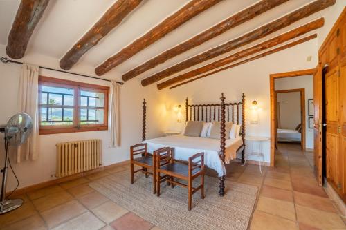 a bedroom with a bed and a table and chairs at Son Poca Palla in Sant Llorenç des Cardassar