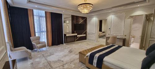 a bedroom with a large bed and a living room at Safo Dushanbe in Dushanbe