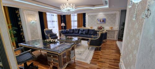 a living room with a couch and chairs and a table at Safo Dushanbe in Dushanbe