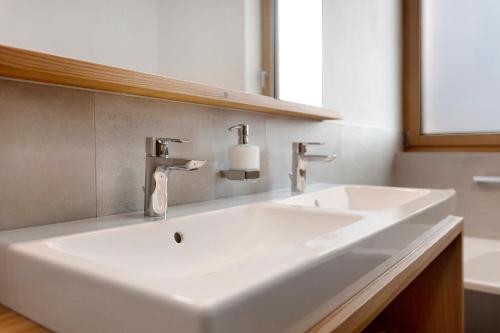 a bathroom with a white sink and a mirror at Noreia Granda in Ortisei