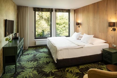 A bed or beds in a room at HERBARIUM boutique hotel