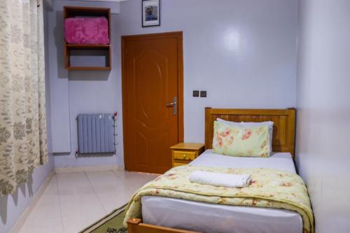a small bedroom with a bed and a wooden door at Hotel Palace Zaida in Zaida