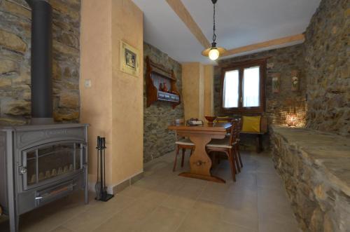 a living room with a wood stove and a table at Casa Rural Urbe in Campodarbe