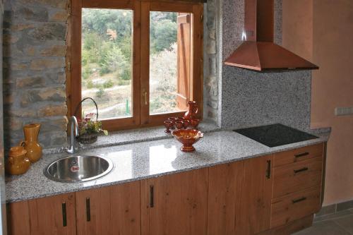 a kitchen counter with a sink and a window at Casa Rural Urbe in Campodarbe