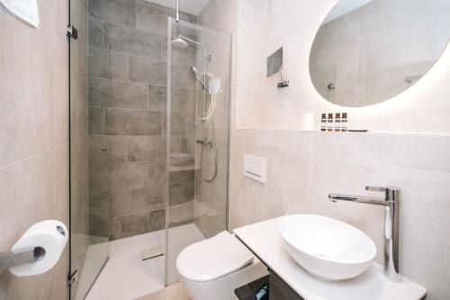 a bathroom with a toilet sink and a shower at Amsterdam Beach Hotel in Zandvoort