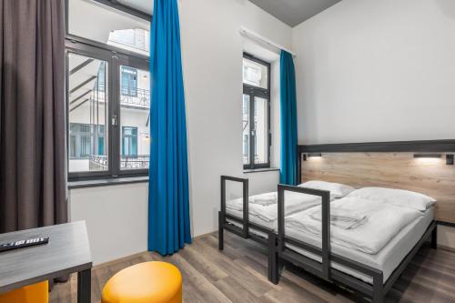 Postel nebo postele na pokoji v ubytování a&o Budapest City
