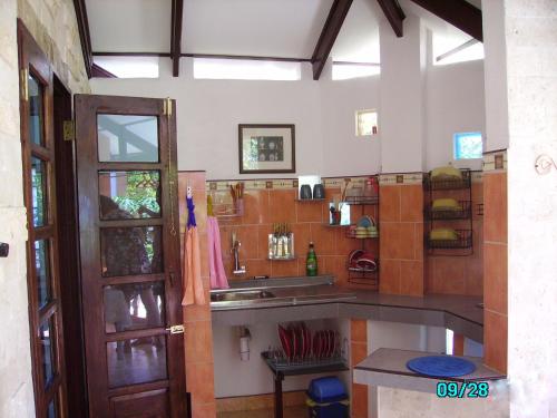 a kitchen with a sink and a counter top at ALONALAND RESORT in Panglao