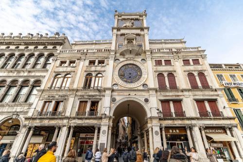 a building with a clock on the front of it at Ca' del Doge San Marco in Venice