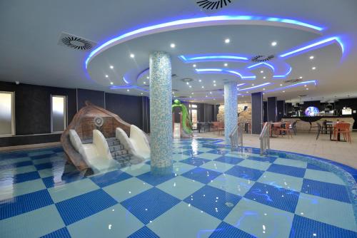 a hotel lobby with a blue ceiling and a checkerboard floor at Spa Resort & Hotel Vrnjačke Terme in Vrnjačka Banja