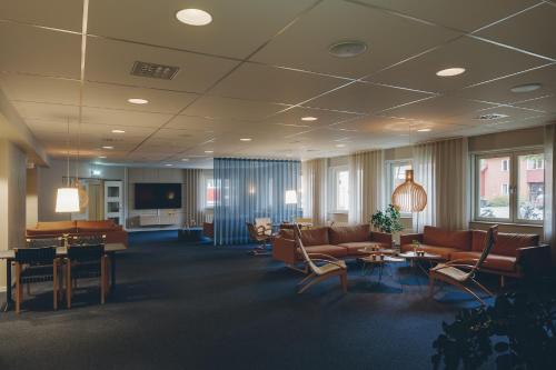 a lobby with couches and chairs and tables at Medlefors Hotell & Konferens in Skellefteå