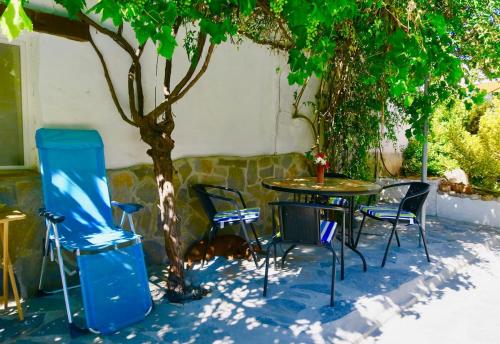a group of chairs and a table under a tree at Cortijo Paraiso in Cúllar de Baza