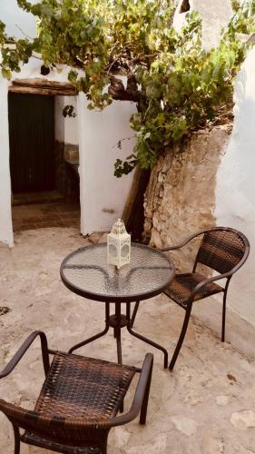 a table and two chairs and a table with a box at Cortijo Paraiso in Cúllar de Baza