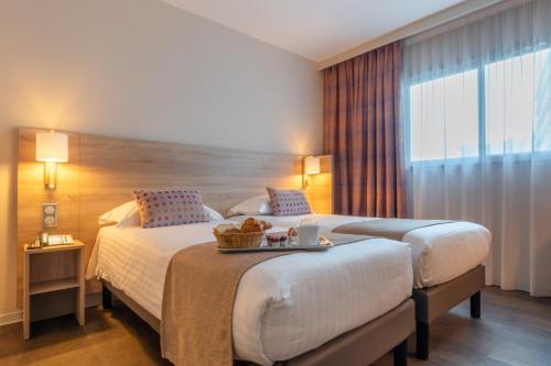 Ένα ή περισσότερα κρεβάτια σε δωμάτιο στο Hôtel L'Empreinte