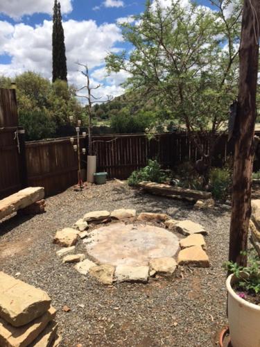 a garden with a stone fire pit in a yard at Bloekomhuis in Smithfield