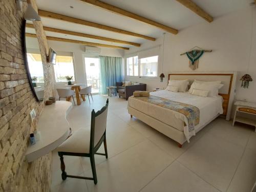 a bedroom with a large bed and a living room at Notus Suites in Plakias