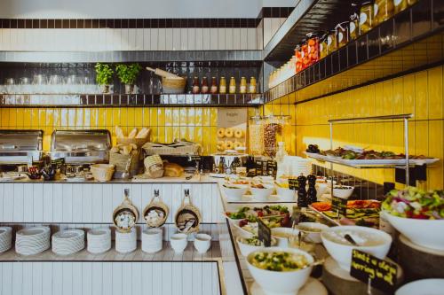 a kitchen with a lot of food on display at Arche Hotel Wrocław Airport in Wrocław