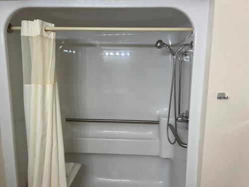a bathroom with a shower with a shower curtain at Express Inn & suites in Decatur