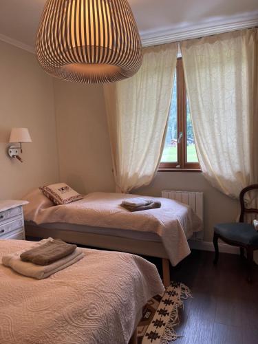 a bedroom with two beds and a chandelier at Nant d Ant in Samoëns