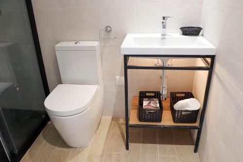 a bathroom with a sink and a toilet at Studios Cielo Madrid in Madrid
