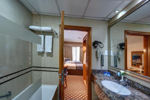 a bathroom with a sink and a mirror at Orchid Hotel Al Barsha "Formerly Golden Tulip Hotel Al Barsha" in Dubai