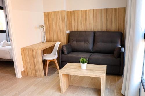 a living room with a couch and a table at Studios Cielo Madrid in Madrid