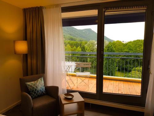 a room with a window with a view of a deck at Hotel Graf Eberhard in Bad Urach