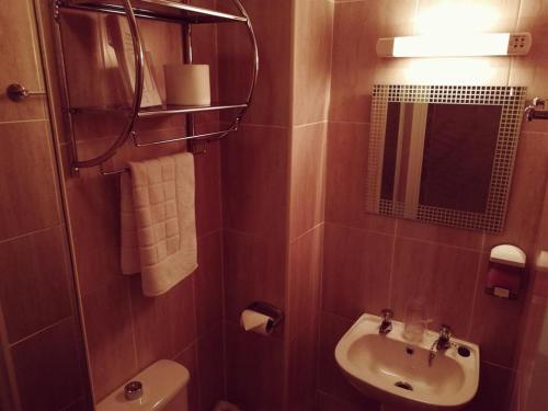 スランディドノにあるDel Marのバスルーム(洗面台、トイレ、鏡付)