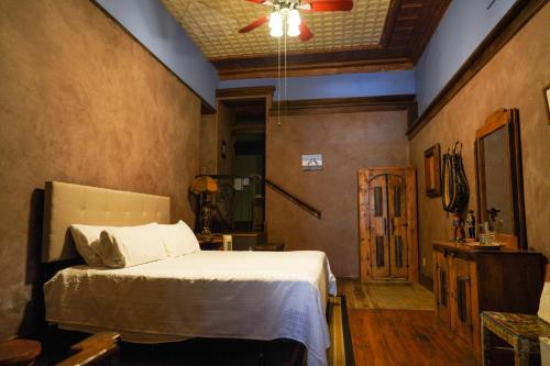 a bedroom with a bed and a ceiling fan at Bisbee Grand Hotel in Bisbee