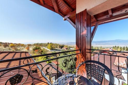 a balcony with two chairs and a view at Complex Koko Hills in Sapareva Banya