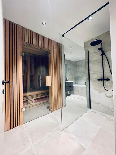 a bathroom with a shower and a glass door at Domaine Sur Les Sarts in Ohey