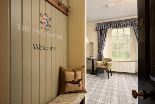a waiting room with a chair and a window at The Pheasant Inn - The Inn Collection Group in Bassenthwaite