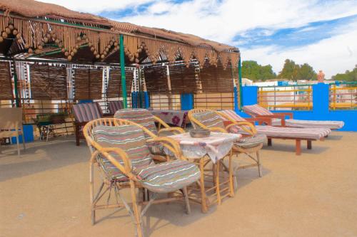 a group of chairs and a table and benches at Nuba Dool in Aswan