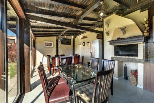 a dining room with a glass table and chairs at Villa Koko Hills in Sapareva Banya