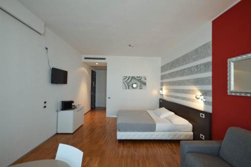 a hotel room with a bed and a couch at Hotel Mantova Residence in Mantova