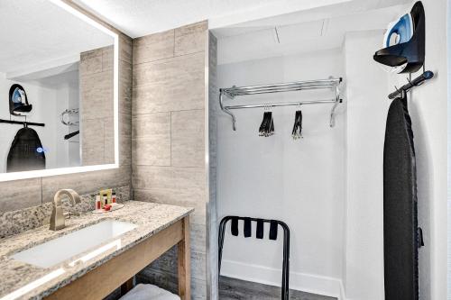 a bathroom with a sink and a mirror at The Harrison Hotel Downtown Hollywood in Hollywood