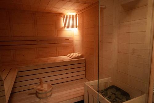 a bathroom with a sauna with a tub and a light at Boutique Hotel U zvonku in Třeboň