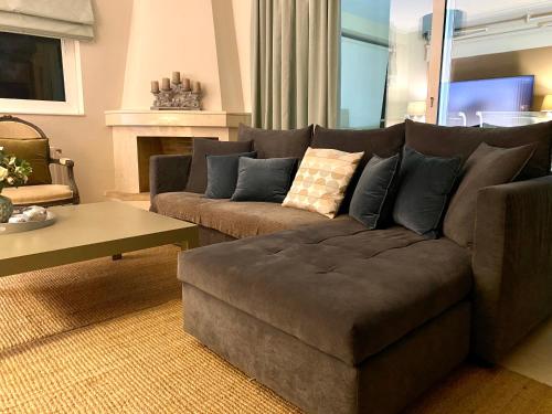a living room with a couch and a coffee table at Marousi Boutique Apartment in Athens