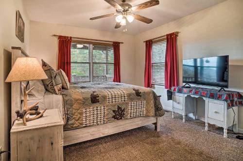 a bedroom with a bed and a flat screen tv at Hiawassee Cabin with Mtn Views Less Than 1 Mi to Lake! in Hiawassee